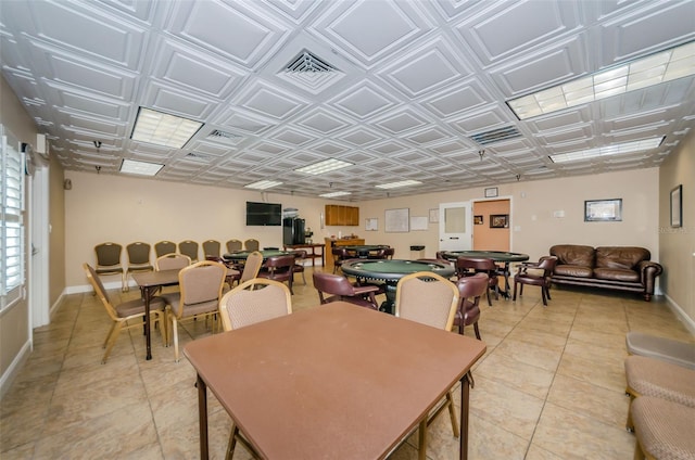 dining room with light tile patterned floors, visible vents, baseboards, and an ornate ceiling