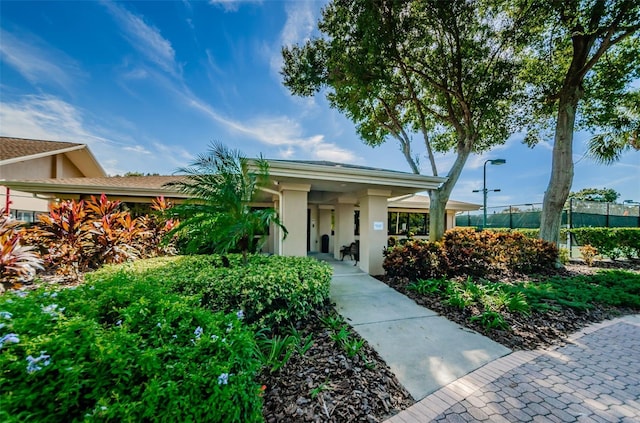 view of front of home with stucco siding and fence