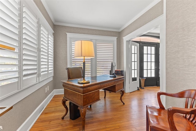 office space with a healthy amount of sunlight, ornamental molding, and light wood-type flooring