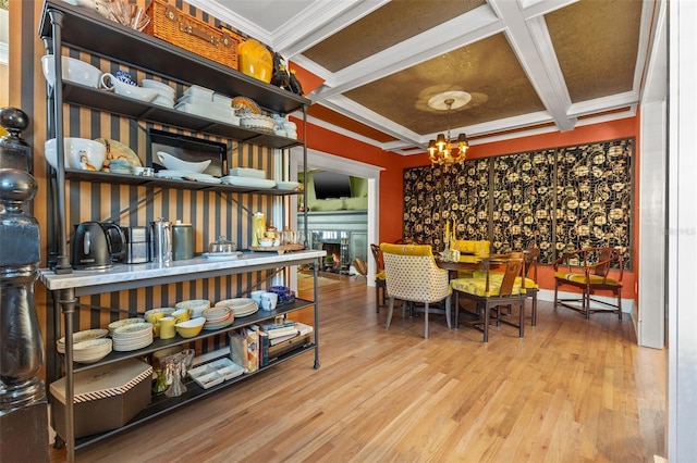 dining space featuring beam ceiling, an inviting chandelier, light wood-type flooring, ornamental molding, and coffered ceiling