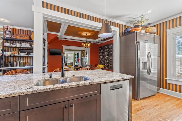 kitchen featuring appliances with stainless steel finishes, sink, light hardwood / wood-style floors, decorative light fixtures, and coffered ceiling