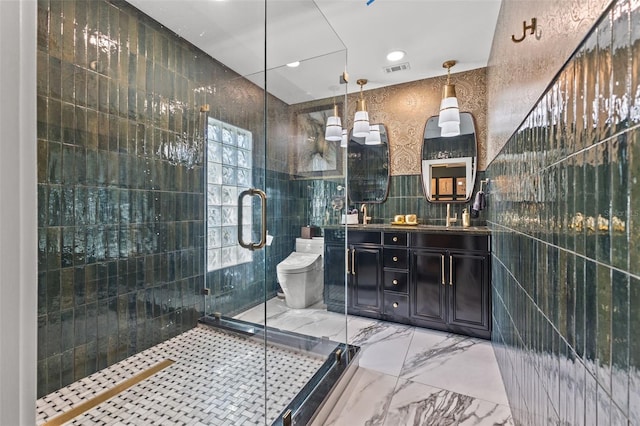 bathroom featuring vanity, toilet, tile walls, and walk in shower