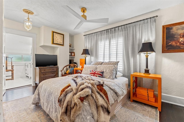 bedroom with hardwood / wood-style floors, a textured ceiling, and ceiling fan