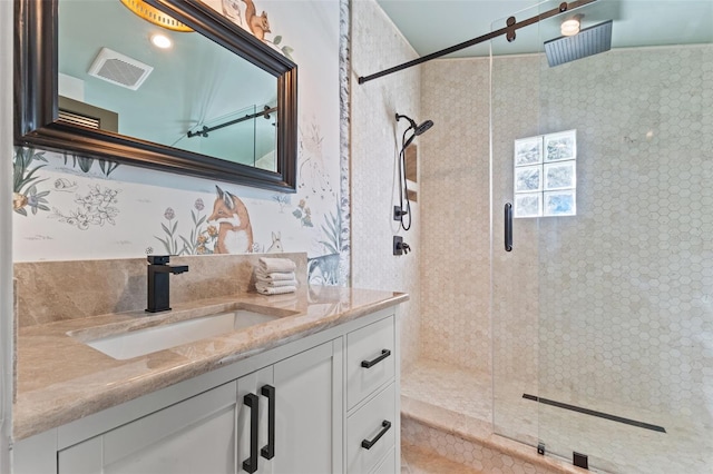 bathroom with vanity and a shower with shower door