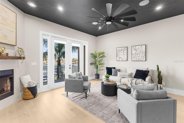 living room featuring light wood-type flooring and ceiling fan