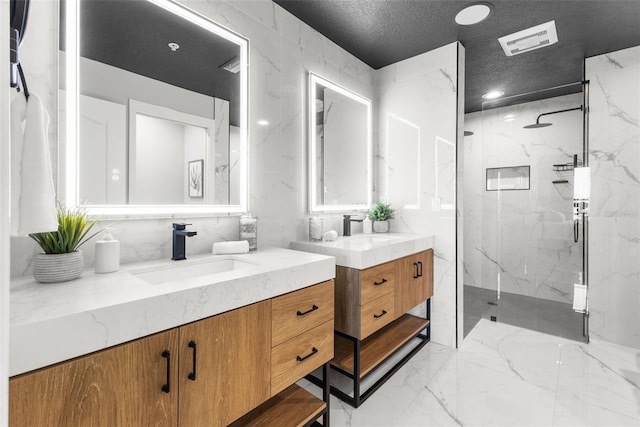 bathroom with vanity, an enclosed shower, a textured ceiling, and tile walls