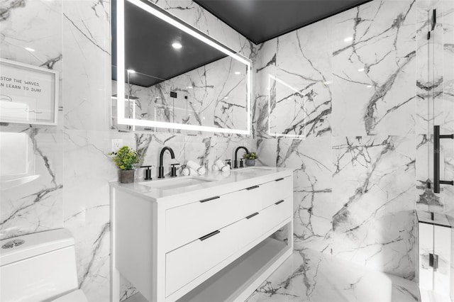 bathroom with vanity, toilet, and tile walls