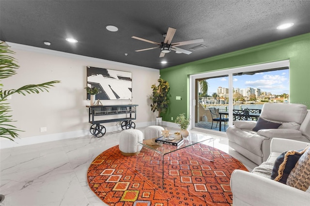 living room featuring ornamental molding, a textured ceiling, and ceiling fan