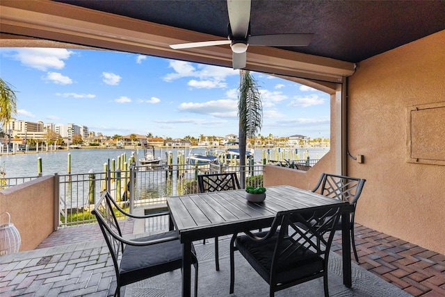 view of patio / terrace featuring a water view, ceiling fan, and a balcony