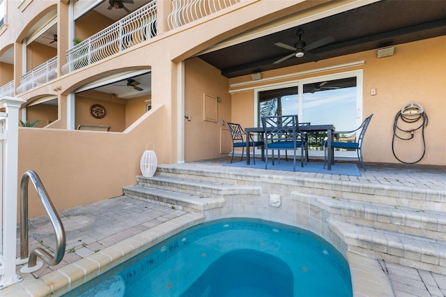 view of swimming pool featuring a patio and ceiling fan