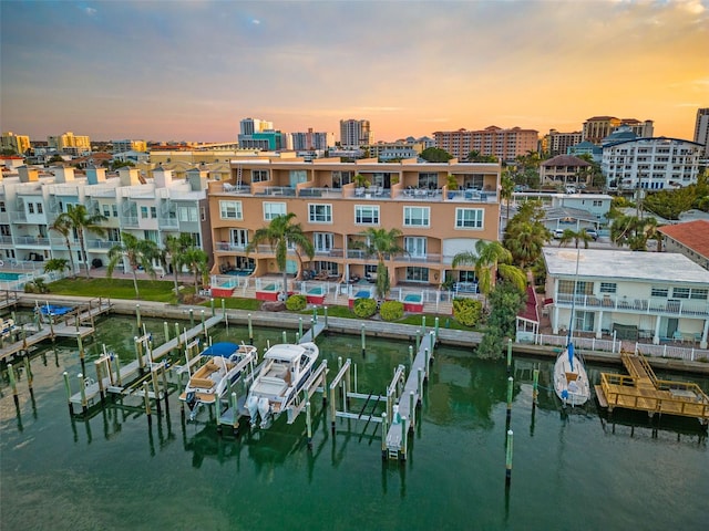 view of dock featuring a water view and a balcony