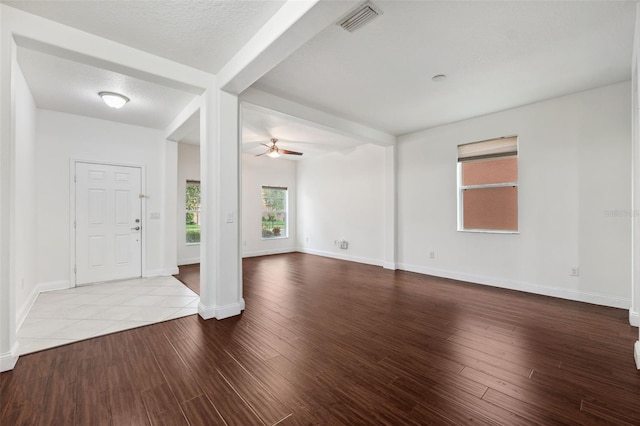 entryway featuring beamed ceiling, ceiling fan, a textured ceiling, and light hardwood / wood-style flooring