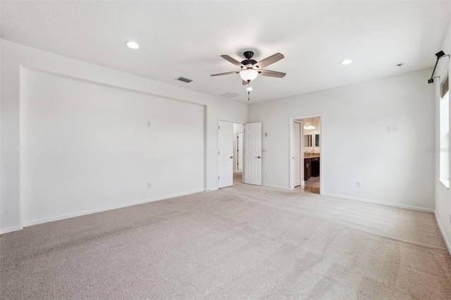 carpeted spare room with ceiling fan