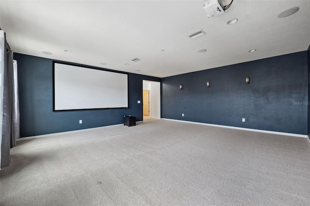 home theater room with light colored carpet