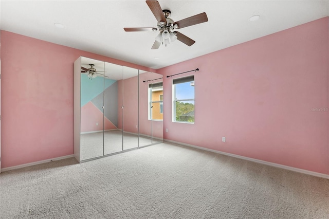 unfurnished bedroom with carpet, ceiling fan, and a closet