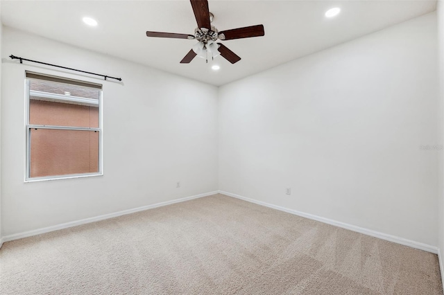 unfurnished room with carpet flooring and ceiling fan