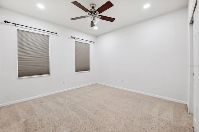 carpeted empty room featuring ceiling fan