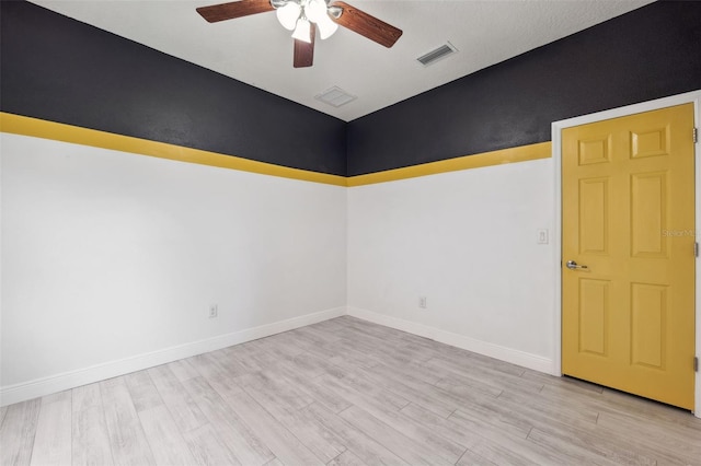 empty room featuring light wood-type flooring and ceiling fan