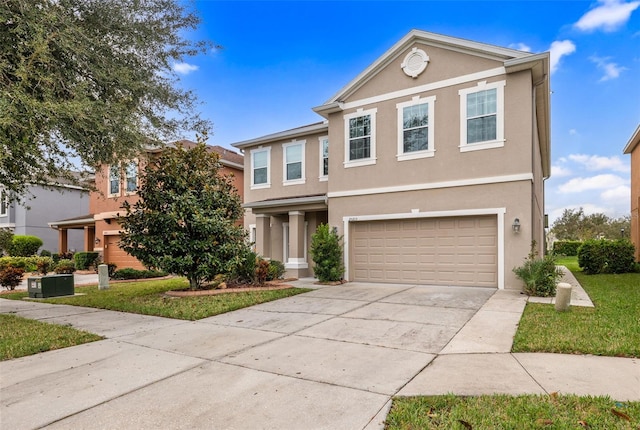 view of front property featuring a garage and a front yard