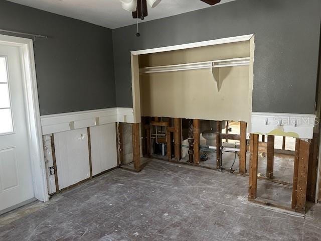 interior space featuring ceiling fan and a closet