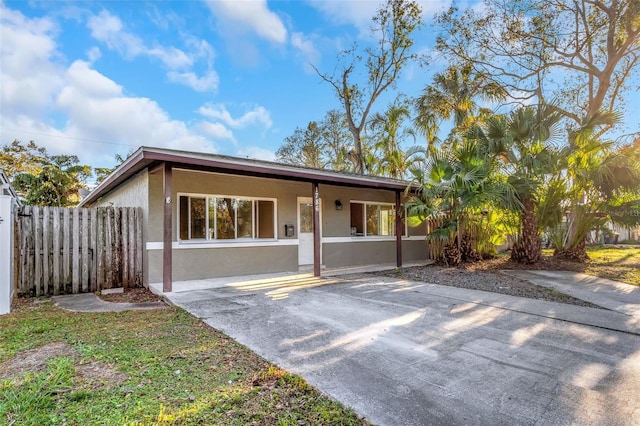 view of front of home with fence and stucco siding