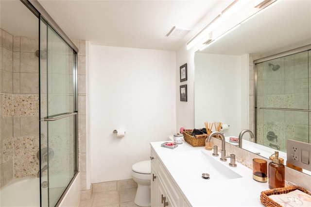 full bathroom featuring vanity, toilet, enclosed tub / shower combo, and tile patterned flooring