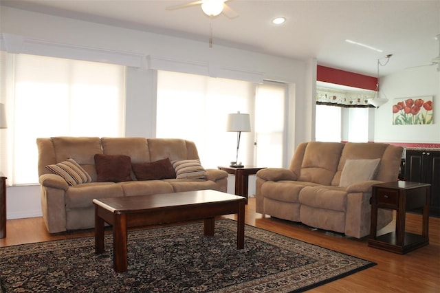 living room featuring hardwood / wood-style flooring and ceiling fan