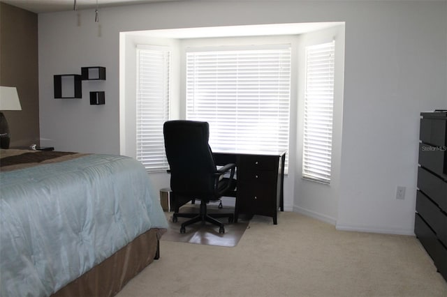 bedroom featuring light carpet