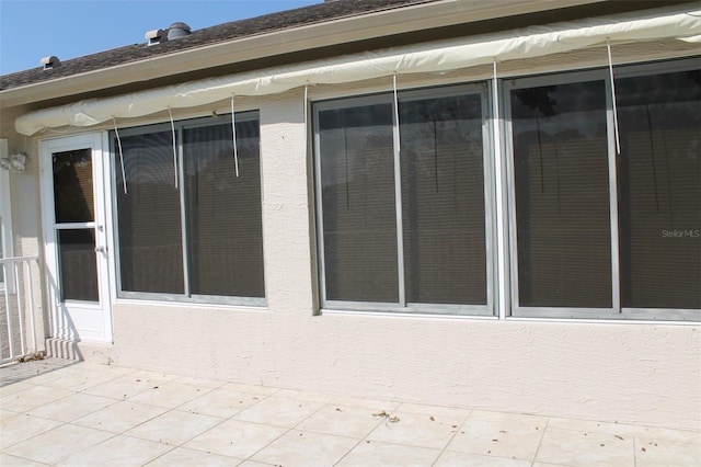 view of side of home with a sunroom