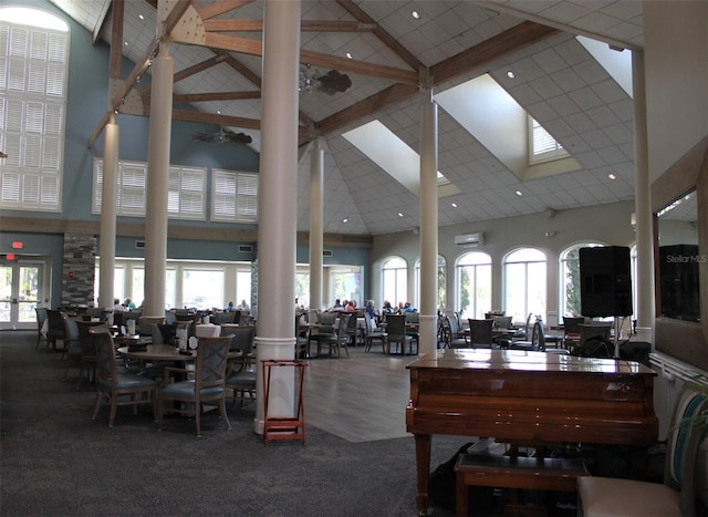 interior space with ornate columns, beam ceiling, high vaulted ceiling, and carpet