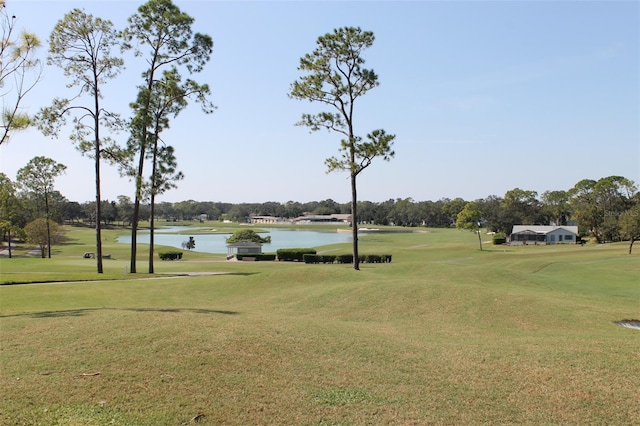 view of property's community featuring a water view and a lawn