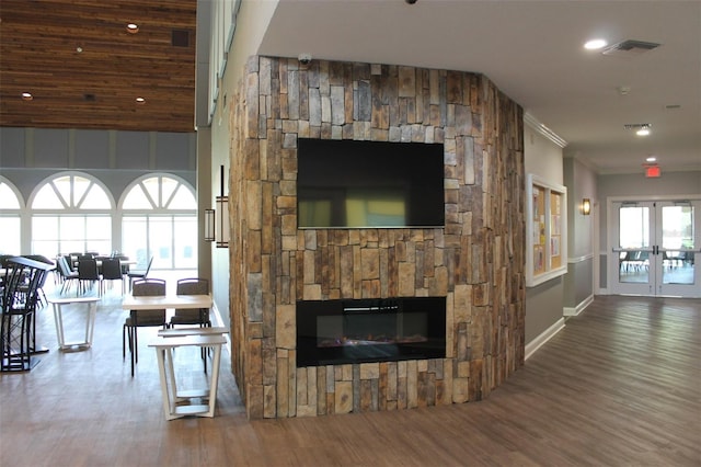 living room with a wealth of natural light, hardwood / wood-style floors, and a fireplace