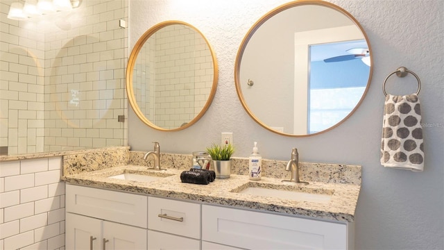 bathroom featuring vanity and tile walls