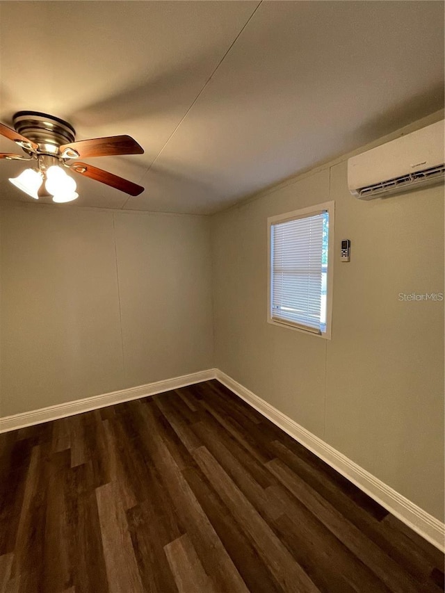 empty room featuring ceiling fan, dark hardwood / wood-style flooring, and a wall unit AC