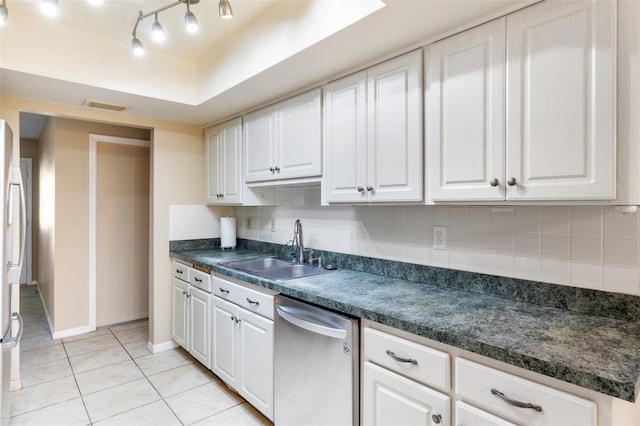 kitchen with white cabinets, sink, stainless steel appliances, and tasteful backsplash