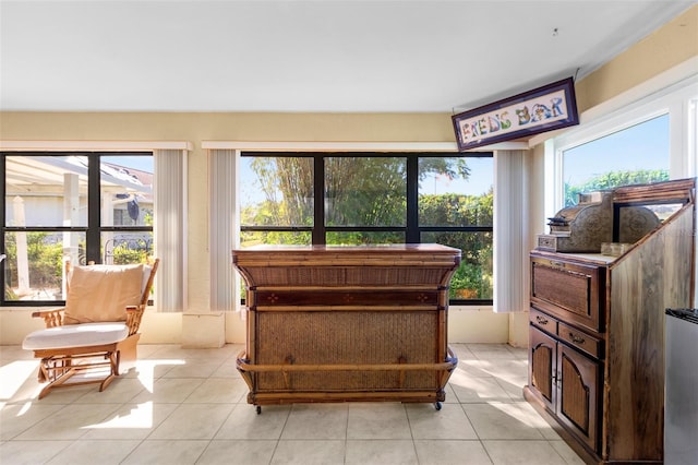 living area featuring a healthy amount of sunlight and light tile patterned floors