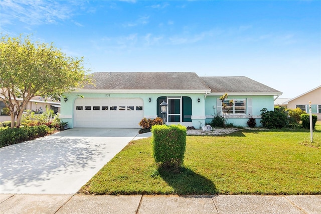 ranch-style home featuring a garage and a front lawn