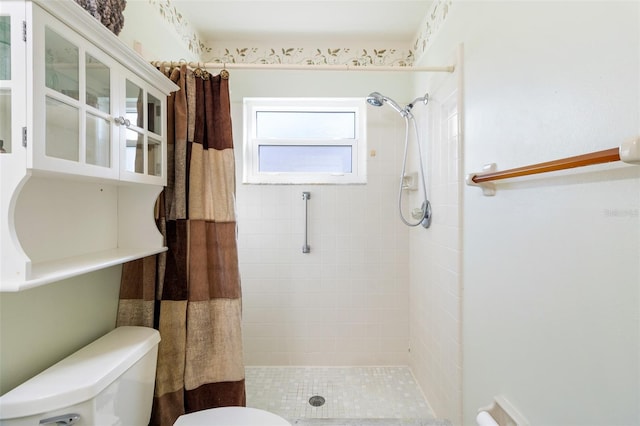 bathroom with a shower with curtain and toilet