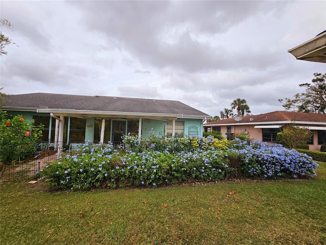 rear view of house with a yard