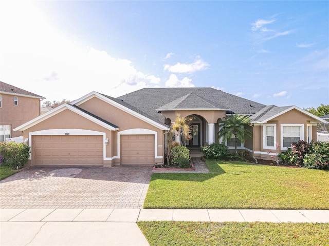 ranch-style house with a garage and a front yard