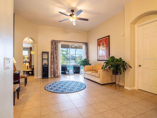 living room featuring ceiling fan and light tile patterned floors