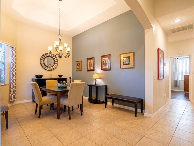 tiled dining area with an inviting chandelier