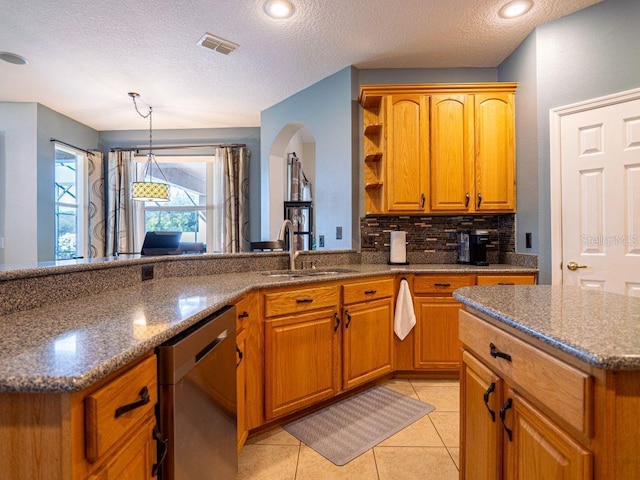 kitchen featuring sink, a kitchen island, stainless steel dishwasher, a textured ceiling, and light tile patterned flooring