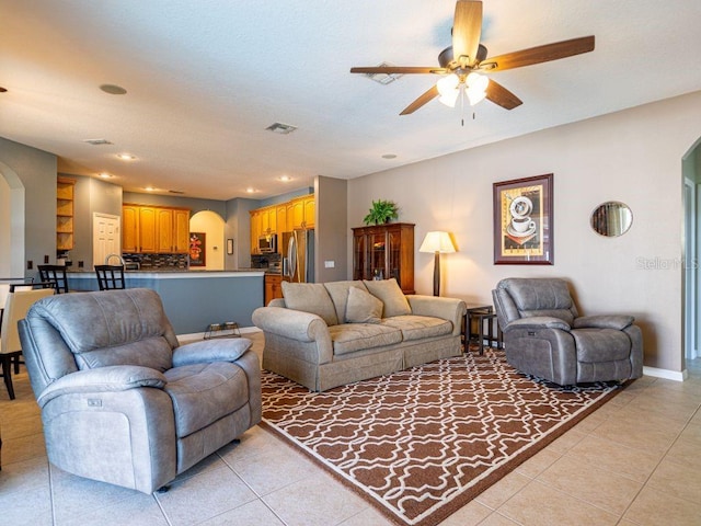 tiled living room featuring ceiling fan