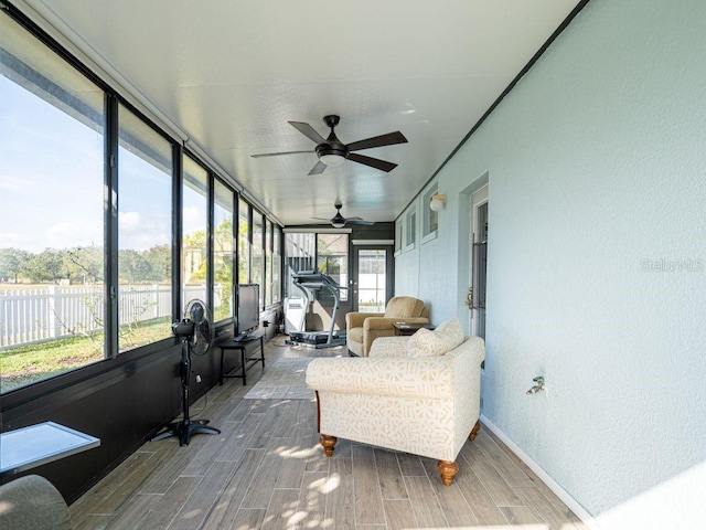 sunroom / solarium featuring a wealth of natural light and ceiling fan