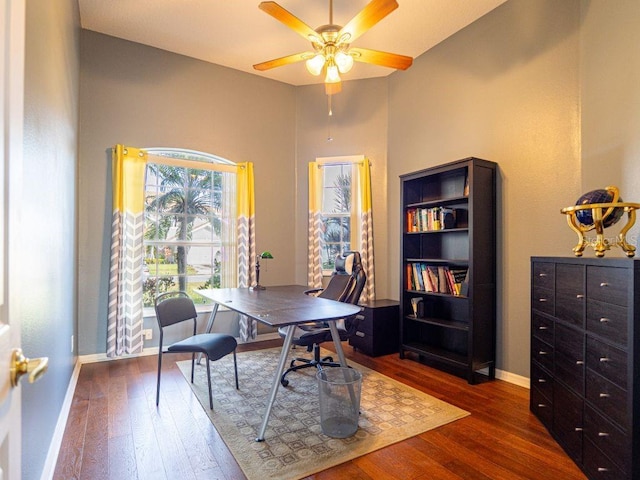 office with dark hardwood / wood-style flooring and ceiling fan