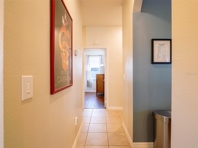 corridor with light tile patterned flooring