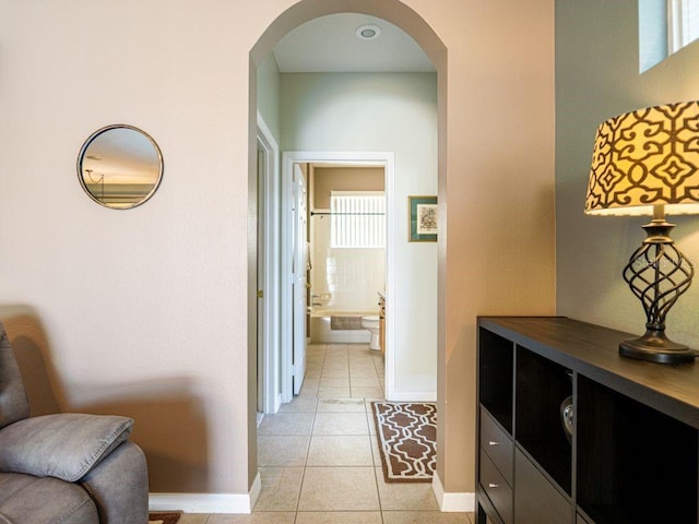 hall with light tile patterned floors