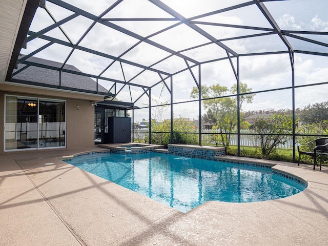 view of swimming pool with glass enclosure, an in ground hot tub, and a patio area