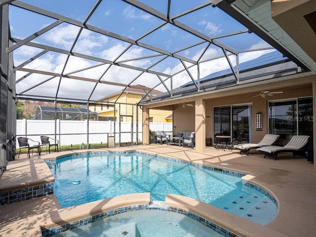 view of pool with ceiling fan, a lanai, and a patio